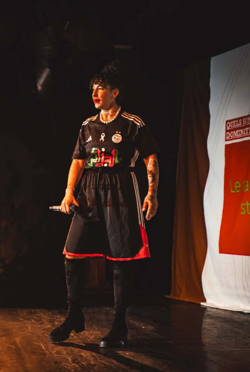 Performer with microphone on stage, Decolonize the dancefloor - Habibitch, La Reine Blanche, Paris, 2025. Photo by Iheb Fehri